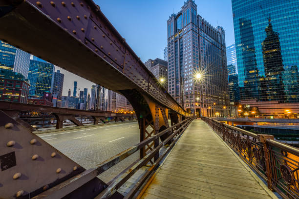 The Chicago Riverwalk at Daybreak Watching the sun rise over the city of Chicago from the Chicago Riverwalk drawbridge photos stock pictures, royalty-free photos & images