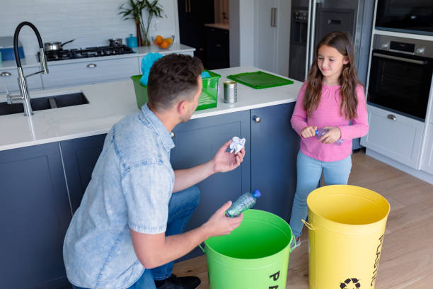 istock Happy caucasian father and daughter segregating rubbish 1342319943