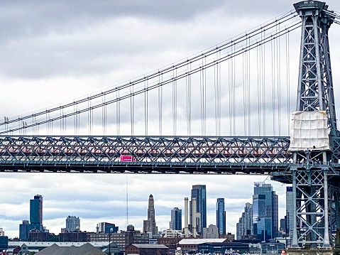A view of the Williamsburg Bridge from John V. Lindsay East River Park on an overcast spring day