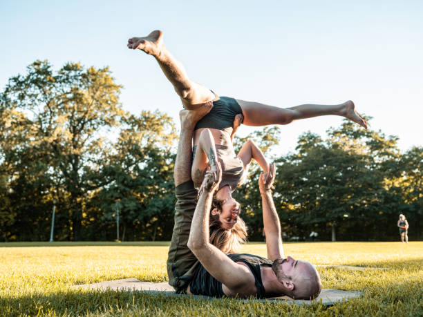 istock Young couple practising Acro Yoga in the park 1342324092