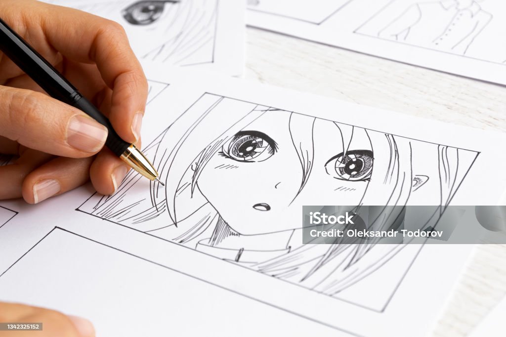 The artist draws anime comics on paper. Storyboard for the cartoon. The illustrator creates sketches for the book. Manga Style Stock Photo