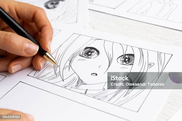 The Artist Draws Anime Comics On Paper Storyboard For The Cartoon The Illustrator Creates Sketches For The Book Stock Photo - Download Image Now