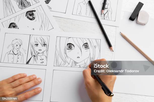 The Artist Draws Anime Comics On Paper Storyboard For The Cartoon The Illustrator Creates Sketches For The Book Manga Style Stock Photo - Download Image Now