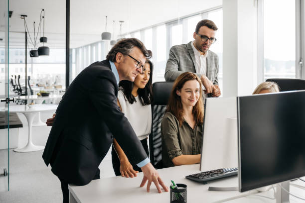istock Photo of co-workers looking at a computer 1342328803
