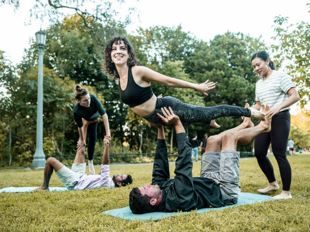 istock People practising Acro Yoga in the park 1342332400