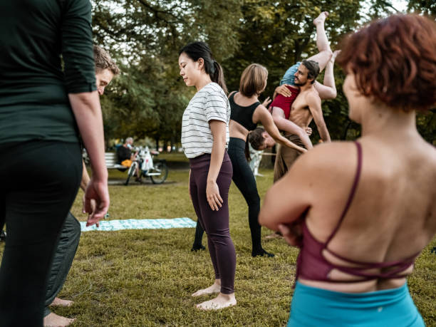 istock People practising Acro Yoga in the park 1342332459