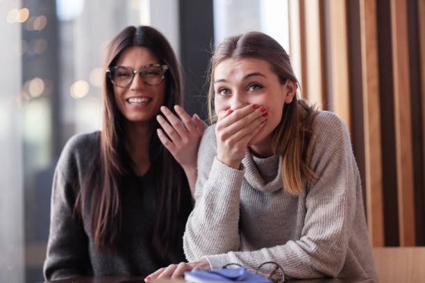 istock Two lovely girls in a cafe laughing having fun. 1342336438