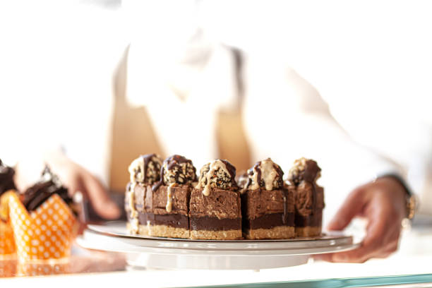 istock Waiter hands holding chocolate cake in a restaurant.. 1342336479