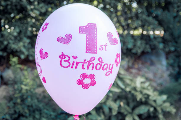 istock First birthday decoration with candys and balloon. 1342337929