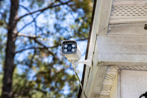 Security camera mounted to house eve stock photo