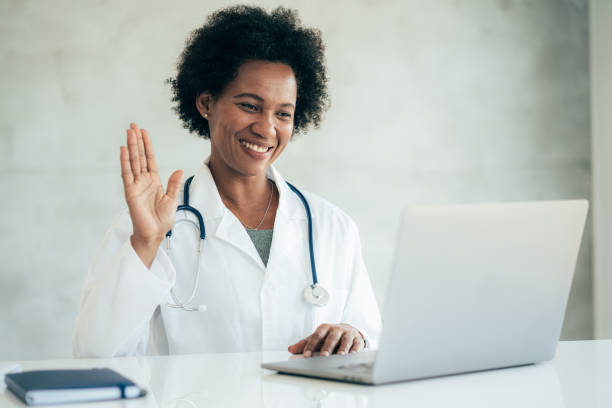 istock Senior doctor speaks with patient using laptop online 1342346315