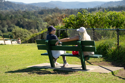 Sydney, Australia, 23 September 2021- Two seniors women relaxing on the bench at Mona Vale Headland Park on a sunny day