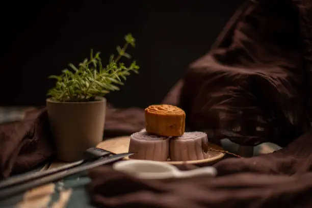 Chinese cakes are on the gray cloth of the wooden table