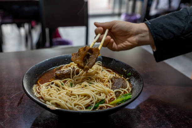 Pick up Chinese food with chopsticks