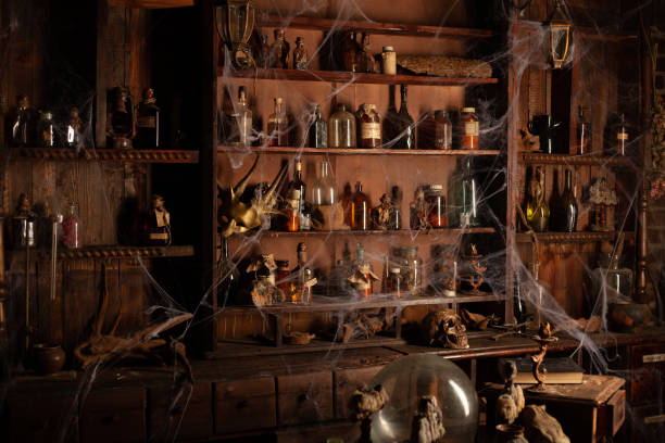 halloween background shelves with alchemy tools skull spiderweb bottle with poison candles - old laboratory alchemy alchemist imagens e fotografias de stock