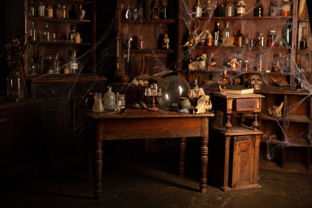 halloween background shelves with alchemy tools skull spiderweb bottle with poison candles - alchemist imagens e fotografias de stock