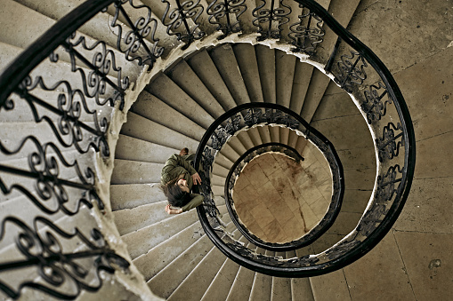 Beautiful young girl on a spiral staircase. Vintage.