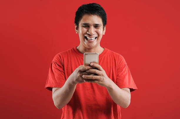 istock Happy Asian man reading new text on mobile 1342352712