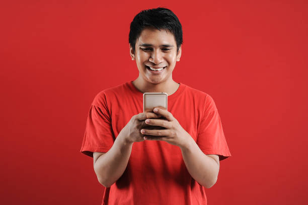 istock Happy Asian man reading new text on mobile 1342352717