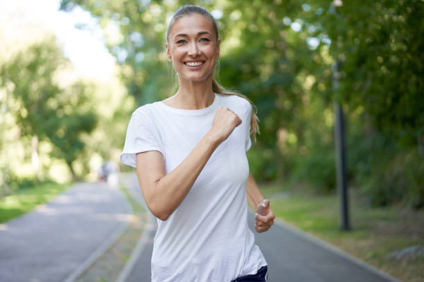 istock Woman running asphalt road summer park 1342352779