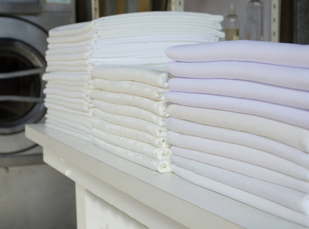 istock Stack of folded white fabrics, bed sheets, tablecloths in an industrial laundry. 1342354144