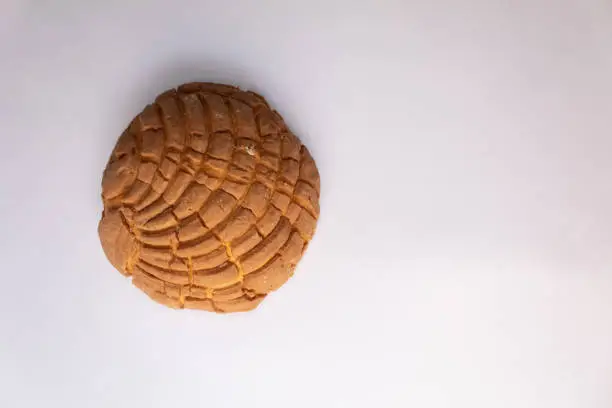 top view of a delicious traditional Mexican sweet bread called concha on a white background
