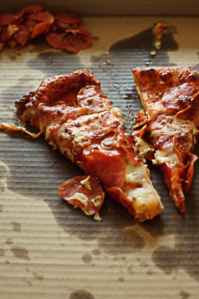 istock Two Pieces of Pizza in Original Cardboard Container 1342361055