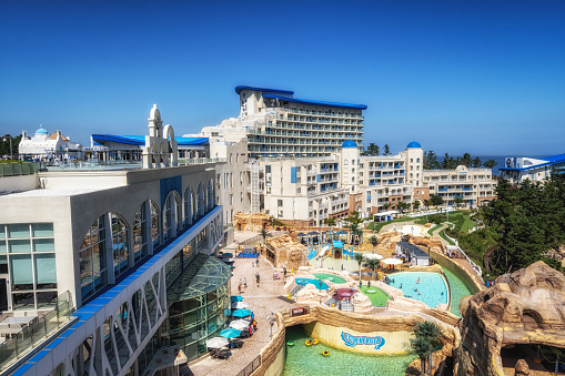 Dubai, United Arab Emirates - January 8, 2023: Iconic Burj Al Arab next to luxury resort and shopping destination Madinat Jumeirah. The resort provides luxury hotel rooms and hosts vast variety of entertainment facilities including fine dining restaurants.