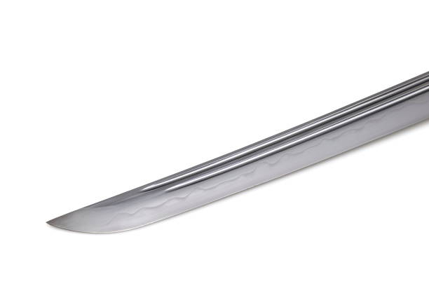 istock Japanese sword blade (made in China) on white background. Soft focus.  The wavy pattern on the blade edge is a line of hardness that a blacksmith makes so that the blade doesn't break. 1342367093