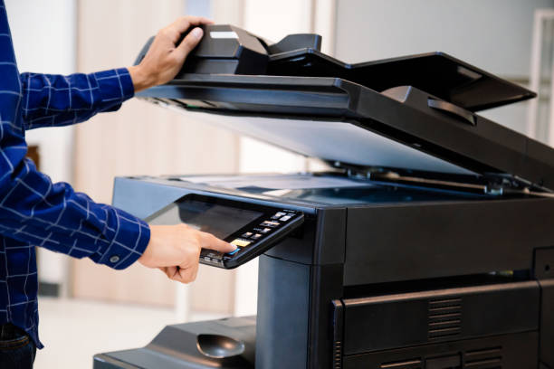 istock Businessmen press button on the panel for using photocopier or printer for printout and scanning document paper at office. 1342371358