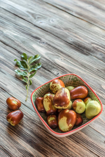 istock Fresh Jujube or Chinese Red Date Served on Rustic Wooden Backgrounds 1342371365
