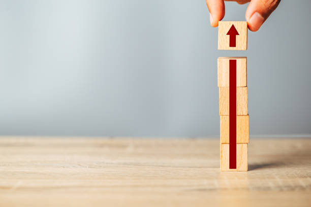 istock Hand arranging wood block stacking as step stair with arrow up.Ladder career path for business growth success process concept. 1342371979