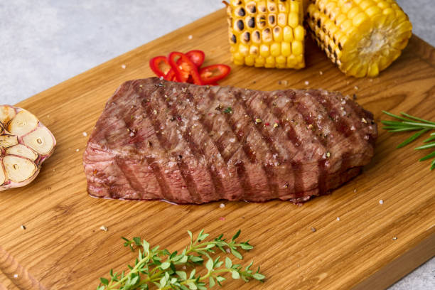 istock Grilled striploin steak with corn, garlic, red chili pepper, salt, rosemary, thyme 1342374686