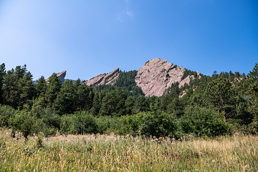 Top of the mountain in focus. Beautiful scenery at the Chautauqua Park Hiking area. The famous flatirons rock formation is visible.