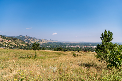 Boulder, CO - August 29, 2021: The Boulder cityscape visible in the distance at the Chautauqua Park Hiking area.