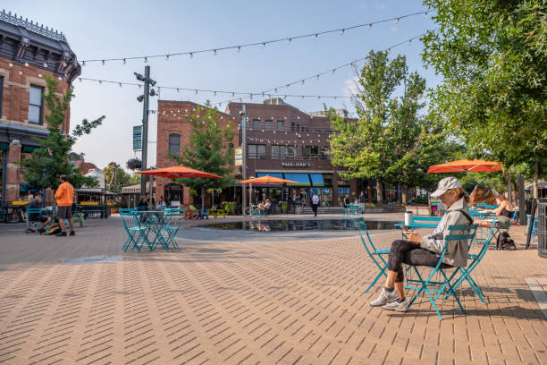 People hang out in Old Town Square in Fort Collins, Colorado stock photo