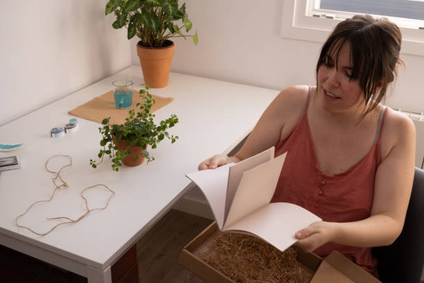 istock young woman opening a gift at home 1342382944