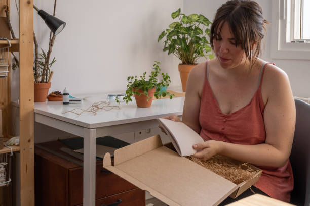 istock young woman opening a gift at home 1342382946