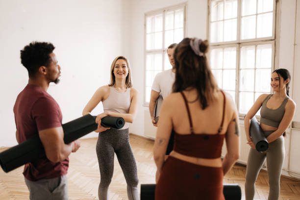istock Young people having a great time at a group workout in a bright yoga studio 1342384296