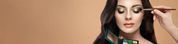 istock Makeup artist applies eye shadow 1342384449