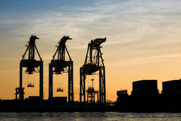 istock sunrise view with container crane's silhouette background 1342384472