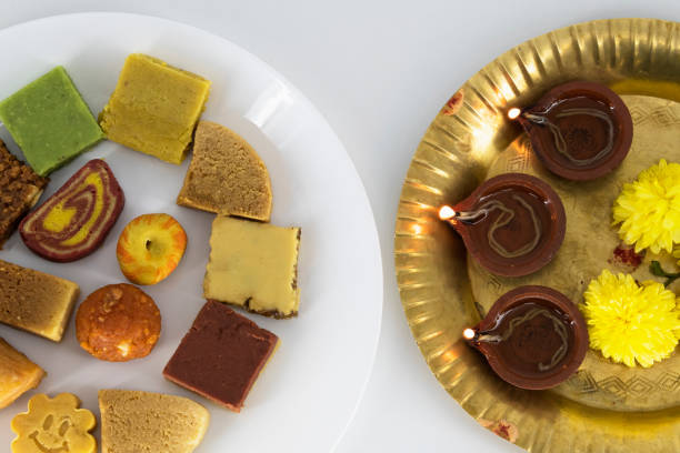 Selective focused Treditional Indian Diwali salty snacks and foods items and empty lamp on an isolated background. Tamilnadu snacks for the Diwali festival.