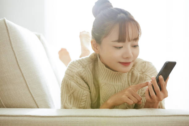 istock A young Asian woman operating a phone at home 1342388618