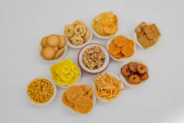 istock Selective focused Treditional Indian Diwali salty snacks and foods items and empty lamp on an isolated background. Tamilnadu snacks for the Diwali festival. 1342388681