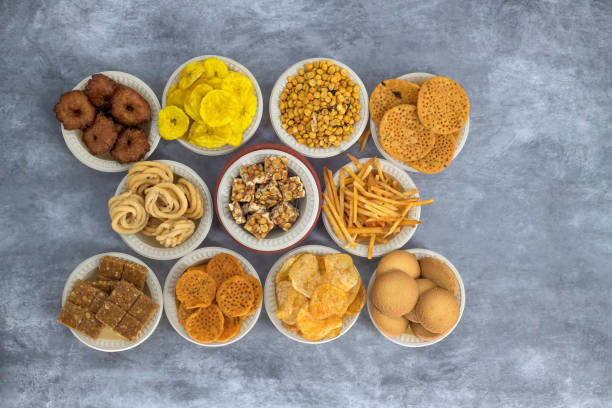 istock Selective focused Treditional Indian Diwali salty snacks and foods items and empty lamp on an isolated background. Tamilnadu snacks for the Diwali festival. 1342388733