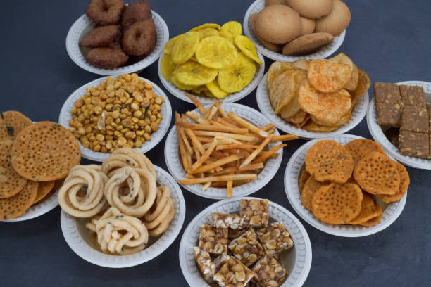 istock Selective focused Treditional Indian Diwali salty snacks and foods items and empty lamp on an isolated background. Tamilnadu snacks for the Diwali festival. 1342388777