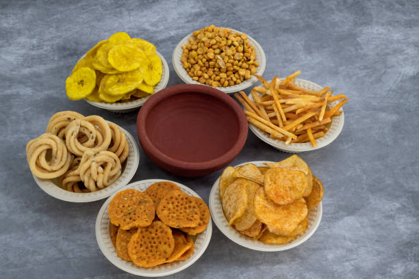 istock Selective focused Treditional Indian Diwali salty snacks and foods items and empty lamp on an isolated background. Tamilnadu snacks for the Diwali festival. 1342388778