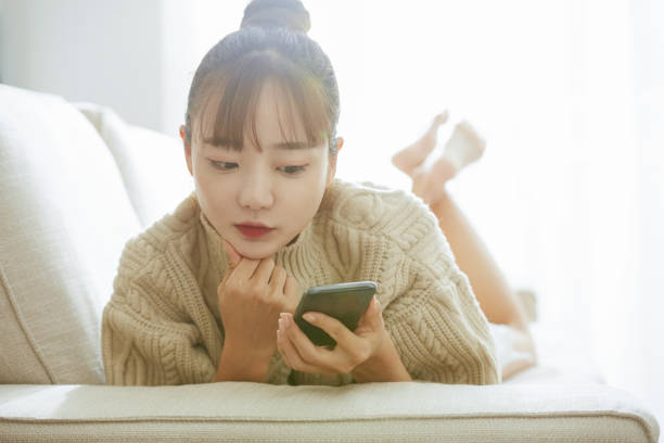 istock A young Asian woman operating a phone at home 1342388793