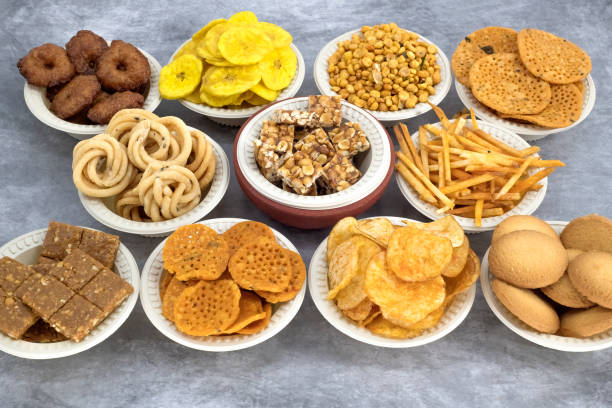 istock Selective focused Treditional Indian Diwali salty snacks and sweets , foods items and empty lamp on an isolated background. Tamilnadu snacks for the Diwali festival. 1342388808