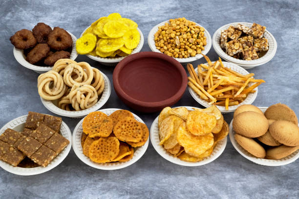 istock Selective focused Treditional Indian Diwali salty snacks and foods items and empty lamp on an isolated background. Tamilnadu snacks for the Diwali festival. 1342388844